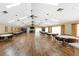 Well-lit meeting room features tables, chairs, wood floors, and neutral walls for a versatile space at 20016 Sancraft Ave, Port Charlotte, FL 33954