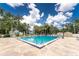 Enjoy the large community pool and exterior seating area surrounded by lush Florida landscape at 20016 Sancraft Ave, Port Charlotte, FL 33954