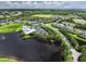 Aerial view of a community featuring tennis courts, pool, community center, and water feature at 2024 Royal Tern Cir, Punta Gorda, FL 33983