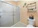 Bathroom with a shower, toilet, and decorative wall art at 2024 Royal Tern Cir, Punta Gorda, FL 33983