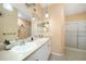 Bathroom featuring dual sinks, a large mirror, and a separate shower area at 2024 Royal Tern Cir, Punta Gorda, FL 33983
