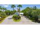 Community entrance with well-manicured landscaping, decorative palm trees, and manicured lawn at 2024 Royal Tern Cir, Punta Gorda, FL 33983