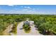 Community entrance with well-manicured landscaping, decorative palm trees, and manicured lawn at 2024 Royal Tern Cir, Punta Gorda, FL 33983