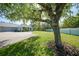 Scenic view of home with expansive yard and mature tree, offering a serene and private outdoor space at 2024 Royal Tern Cir, Punta Gorda, FL 33983