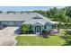 Inviting single-story home with a well-manicured lawn, screened entrance, and attached two-car garage at 2024 Royal Tern Cir, Punta Gorda, FL 33983