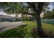 Scenic view of home with expansive yard and mature tree, offering a serene and private outdoor space at 2024 Royal Tern Cir, Punta Gorda, FL 33983