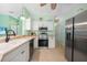 Well-lit kitchen features updated appliances, white cabinetry, and a neutral countertop at 2024 Royal Tern Cir, Punta Gorda, FL 33983