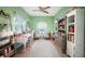 Bright office space with a white desk, shelving, and a large area rug at 2024 Royal Tern Cir, Punta Gorda, FL 33983