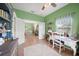 Office area with a white desk, shelving, and view into the living room at 2024 Royal Tern Cir, Punta Gorda, FL 33983