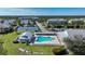 Aerial view of the community pool, tennis courts, clubhouse, and surrounding lush landscaping at 2024 Royal Tern Cir, Punta Gorda, FL 33983