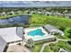 Aerial view of a community pool, lounge chairs and tables plus well-manicured landscaping at 2024 Royal Tern Cir, Punta Gorda, FL 33983