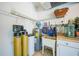 Functional utility area featuring a water heater, filtration system, and storage shelves for convenience at 2024 Royal Tern Cir, Punta Gorda, FL 33983