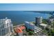 Stunning aerial view showcasing waterfront condos with city skyline, beautiful bay, and lush greenery creating a peaceful setting at 2401 Bayshore Blvd # 1204, Tampa, FL 33629