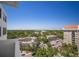 High-rise balcony offers expansive city views, showcasing lush greenery and clear blue skies at 2401 Bayshore Blvd # 1204, Tampa, FL 33629