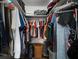 Ample storage space is provided by this well-organized, walk-in closet with custom shelving at 2401 Bayshore Blvd # 1204, Tampa, FL 33629