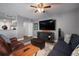 Comfortable living room features hardwood floors, gray walls, TV, ceiling fan, and modern furnishings at 2401 Bayshore Blvd # 1204, Tampa, FL 33629