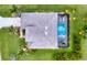 Aerial view of a home featuring a pool, lush greenery, and a well-maintained outdoor space at 24103 Pyramid Way, Punta Gorda, FL 33955