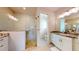 This bathroom has marble countertops, a large shower and white cabinets at 24103 Pyramid Way, Punta Gorda, FL 33955