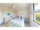 Bedroom with carpet floors, ceiling fan, and decorated with blue and green decor at 24103 Pyramid Way, Punta Gorda, FL 33955
