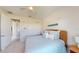 Bright bedroom with a queen bed, wicker headboard, and access to a full bathroom at 24103 Pyramid Way, Punta Gorda, FL 33955