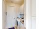 Bright laundry room with a front-load washer, dryer, and storage cabinets at 24103 Pyramid Way, Punta Gorda, FL 33955