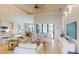 Bright open living area with white furniture, a chef's kitchen and large windows overlooking the pool at 24103 Pyramid Way, Punta Gorda, FL 33955