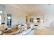 Open concept living room and kitchen with breakfast bar seating and light hardwood floors at 24103 Pyramid Way, Punta Gorda, FL 33955