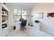 Home office with large window, computer desk and white cabinetry at 24103 Pyramid Way, Punta Gorda, FL 33955