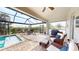 Screened in pool area with brick floors and outdoor furniture at 24103 Pyramid Way, Punta Gorda, FL 33955