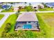 Aerial view of a beautiful home with a screened-in pool and well-maintained landscaping at 24103 Pyramid Way, Punta Gorda, FL 33955