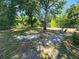 Large fenced backyard with mature trees providing plenty of shade, perfect for relaxing at 243 Harbor Blvd, Port Charlotte, FL 33954