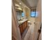 Bathroom featuring wood cabinets, tile flooring and shower with modern mirror at 243 Harbor Blvd, Port Charlotte, FL 33954