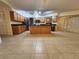 Spacious kitchen featuring oak cabinets, tile floors, island and black appliances at 243 Harbor Blvd, Port Charlotte, FL 33954