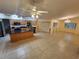 Open kitchen boasts wood cabinets, a black countertop island, and seamless flow into the dining area at 243 Harbor Blvd, Port Charlotte, FL 33954