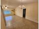 Inviting living room with vaulted ceiling, chandelier and large window with abundant natural light at 243 Harbor Blvd, Port Charlotte, FL 33954