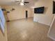 Spacious living room with tile floors, ceiling fan, neutral paint, and television at 243 Harbor Blvd, Port Charlotte, FL 33954
