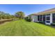 This property features a well-kept lawn and landscaping, bordering a scenic canal at 2508 Magnolia Cir, North Port, FL 34289