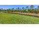 A spacious backyard provides access to a serene canal, bordered by well-maintained green lawns at 2508 Magnolia Cir, North Port, FL 34289