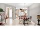 Inviting dining area with a chandelier, tile floors, and easy access to the kitchen, perfect for entertaining at 2508 Magnolia Cir, North Port, FL 34289