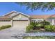 Charming single-story home with a three-car garage, well-manicured landscaping, and a cozy front patio at 2508 Magnolia Cir, North Port, FL 34289