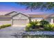Charming single-story home with a three-car garage, well-manicured landscaping, and a cozy front patio at 2508 Magnolia Cir, North Port, FL 34289