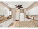 Bright kitchen featuring granite countertops, breakfast bar, white cabinets, and stainless steel appliances at 2508 Magnolia Cir, North Port, FL 34289