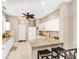 Bright kitchen featuring granite countertops, breakfast bar, white cabinets, and stainless steel appliances at 2508 Magnolia Cir, North Port, FL 34289
