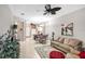 Comfortable living room area with neutral walls, tile flooring, and a ceiling fan for a relaxing atmosphere at 2508 Magnolia Cir, North Port, FL 34289