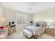 Serene main bedroom with plantation shutters, a ceiling fan, and neutral decor for a relaxing retreat at 2508 Magnolia Cir, North Port, FL 34289