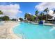 Sparkling blue pool surrounded by lounge chairs and lush landscaping at 2508 Magnolia Cir, North Port, FL 34289