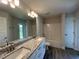 Bathroom featuring a double vanity with granite counters and a shower-tub combination at 25156 Rosamond Ct, Punta Gorda, FL 33983