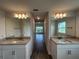 Bathroom featuring dual vanities with granite counters and wood-look flooring at 25156 Rosamond Ct, Punta Gorda, FL 33983