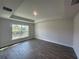 Bright bedroom featuring wood-look floors and a large window overlooking the canal at 25156 Rosamond Ct, Punta Gorda, FL 33983