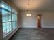 Dining area with a chandelier and a large window offering an abundance of natural light at 25156 Rosamond Ct, Punta Gorda, FL 33983